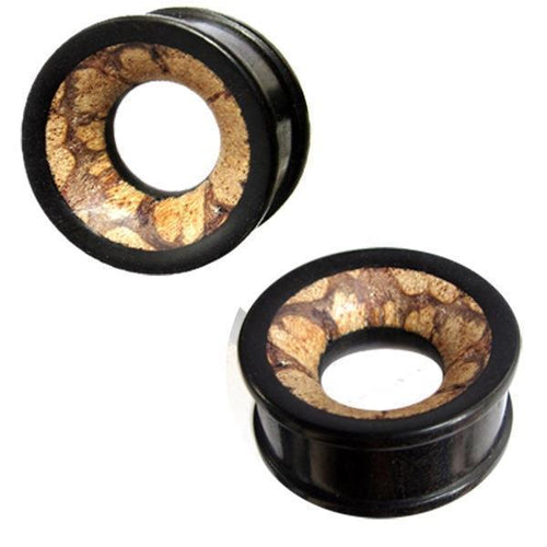 A pair of black circular Holztunnel Eisenholz plugs with open centers, featuring a hand-carved brown patterned Antikholzinlay inspired by Tribal Holz Tunnel designs.