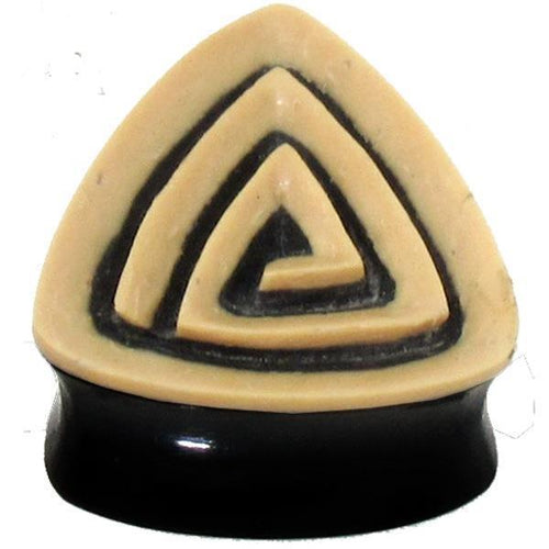 A hand-carved, triangular black and beige Tribal Buffalo Horn Plug with a spiral coconut wood inlay, used as an ear tunnel stud.
