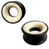 Load image into Gallery viewer, Two black, circular Eisenholz Tribal Plugs with a white Marmor inlay are shown against a white background—one Holztunnel is viewed from the side, the other at an angle. Hand-carved Tunnel schwarz Marmorinlay weiß Expander.

