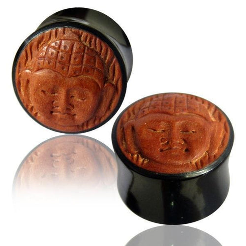 Two Horn Plug Buddha schwarz braun Flesh Tunnel plugs with round wood inlays and carved Buddha design are shown on a white surface, each reflected below.