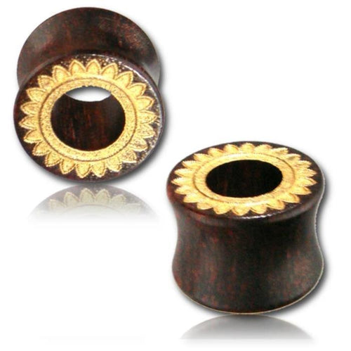 Two dark brown Holz Tunnel Tamarind Wood Tribal Plugs, organic and hand-carved with a gold-painted Sonnenblume laser engraving on the flared front, are displayed against a white background.