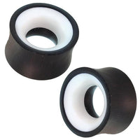 Load image into Gallery viewer, Two hand-carved Holz Tunnel Bone Inlay weiß schwarz Eisenholz Tribal Plugs with a concave, double-flared design and bone inlay accents are displayed on a white background.
