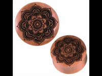 Load image into Gallery viewer, A pair of Sawoholz Plug braun Tunnel Expander Mandala schwarz features dark Mandala designs engraved on their flat surfaces, displayed against a plain white background.
