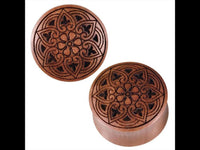 Load image into Gallery viewer, Two round Herz Blumen Muster Lasergravur Sawoholz Tribal Plugs with intricately carved floral and geometric designs on their tops are displayed against a white background.
