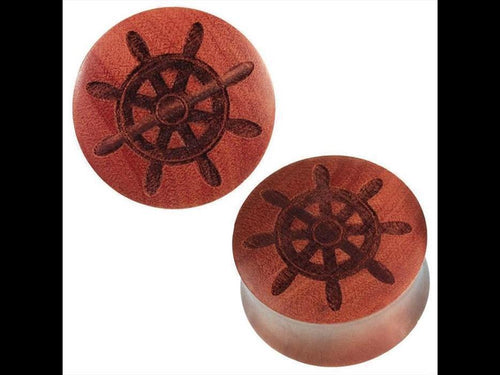 Two round, reddish-brown Rosenholz Plug braun feature a dark Schiffsruder engraving on their flat faces. Handgemacht and organic, these tribal-style plugs are both stylish and unique.
