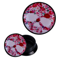 Load image into Gallery viewer, The Schraub Plug Acryl Skull aus roten Rosen Piercing Ohrschmuck is a round black container with a lid displaying a skull made of red roses on white. The lid is shown both attached and removed from the container.
