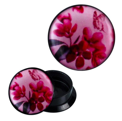 A pair of Schraub Plug Acryl Blumen Schmetterling Blätter rosa pink Ohrschmuck Piercing, featuring black plugs with a pink front decorated with red flowers, green leaves, and a faint butterfly—shown open to reveal the hollow interior.