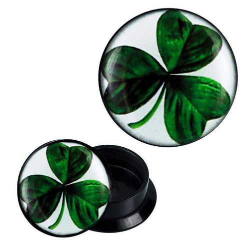 The Schraub Plug Acryl features a green three-leaf clover design on black under a glossy finish, displayed from two angles on a white background.