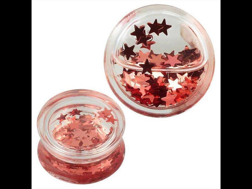 Two small Plug Acryl transparent Flüssigkeit rosa mini Sterne Piercing Ohrschmuck containers are filled with shiny, metallic pink star confetti, some scattered on the lid for a sparkling rosa Stern Effekt.