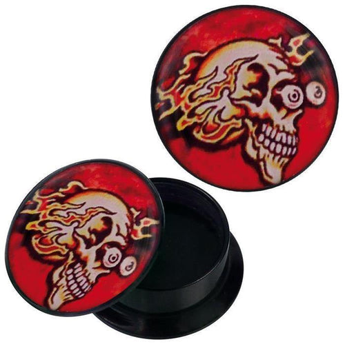 A round black Schraub Plug Acryl container, open to reveal its empty interior. Both the container and its removable lid display a flaming skull with red-yellow eyes on a red background. Ideal for piercing and Ohrschmuck.
