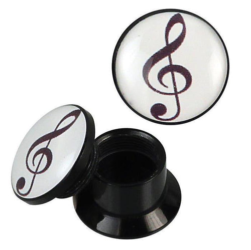 A pair of black and white Schraub Plug Acryl Notenschlüssel Piercing Ohrschmuck ear plugs with removable tops, each showing a black treble clef on a white background. One plug is disassembled to reveal the threaded compartment.