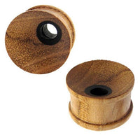 Load image into Gallery viewer, Two Holz Tunnel Plug gemasert Loch klein, hand-carved from Teakholz and Eisenholz, with flared edges and a black center hole, are shown on a white background. One plug stands upright, the other is tilted to display front and side views.
