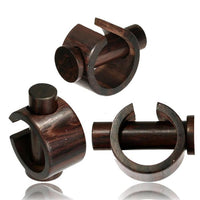 Load image into Gallery viewer, Three Plug Narraholz Pin-Creole napkin rings in brown grained wood, each with a cylindrical form and circular accent, are shown from multiple angles against a white background.
