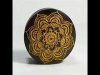 Load image into Gallery viewer, The Holz Plug Mandala Blume Sonoholz in dark brown features a golden engraved mandala design on the front, shown standing upright against a plain light background.
