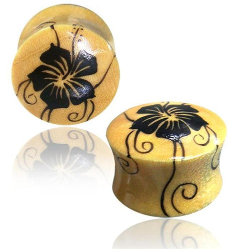 A pair of yellow hand-painted Organic Holz Plug hell Hawaii Blume ear gauges with a glossy finish and black floral design, shown on a white background with reflection.