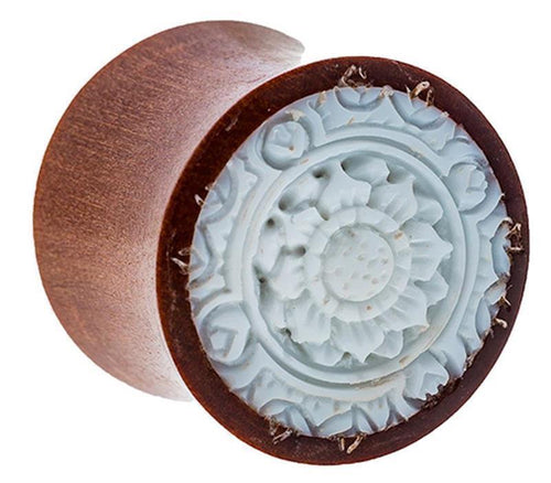 A round Sawoholz Plug in natural brown with a carved floral bone inlay pattern, featuring detailed petals and circular motifs, reminiscent of fine craftsmanship—ideal as an expander tunnel.