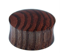 Load image into Gallery viewer, A hand-carved, small, round dome-shaped Zebraholz Plug called "Holzplug Zebraholz handgeschnitzt braun gestreift Tribal Holz Tunnel Plug Expander," featuring a polished surface and striped brown wood grain.
