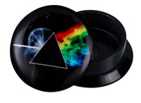 Load image into Gallery viewer, A round black Schraub Plug Acryl Prisma Regenbogen Mond Piercing Ohrschmuck lid shows a prism splitting white light into a rainbow, inspired by The Dark Side of the Moon. The Acryl Plug base is next to the lid.
