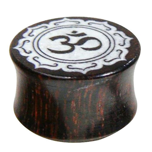 The Holz Plug Tamarinde Bone Inlay Om features dark wood with a white bone inlay of the Om symbol and an oriental carved border for a unique tribal look.