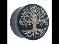 Load image into Gallery viewer, A round black plug, inspired by the Holz Plug Baum des Lebens Yggdrasil silber double flared, features a silver Tree of Life design with spreading branches and roots.
