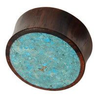 Load image into Gallery viewer, The Holz Plug Sonoholz Crushed Türkis Inlay double flared features a flat round face inlaid with crushed Türkis fragments, creating a bold speckled blue pattern on one end.

