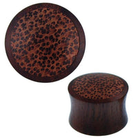 Load image into Gallery viewer, Two views of the Holz Plug Kokosholz Inlay, handgeschnitzt aus Sonoholz, showing its dark brown base and unique textured spotted pattern on the flared surface.
