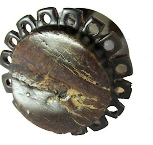 A round, dark brown Horn Plug Blumenform aus Rohhorn, double flared, features a stone-like cracked surface and a ring of evenly spaced holes around the edge, displayed against a white background.