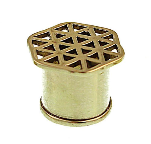 A small, gold-colored, cylindrical Messing Wabe Dreiecke antik gold ribbed Flesh Tunnel with a hexagonal top and geometric cut-out triangles—perfect as a stylish piercing.