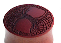 Load image into Gallery viewer, A brown wooden plug, "Plug braun Holz Baum des Lebens dunkel Gravur Flechtrand," features a dark engraved Tree of Life with intricate braided edge detailing—a stylish tribute to natural motifs.
