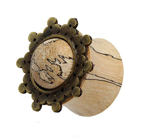 The Holz Plug Tamarinde Punkte Dreiecke features a beige, marbled center with visible dark veining, framed by an ornate Afghan Style Brass gold inlay with floral design for a rustic, antique look.