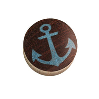 Load image into Gallery viewer, A round Holz Plug Anker made of dark brown Sonoholz, featuring a light blue crushed turquoise stone anchor inlay on top, set against a white background.

