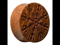 Load image into Gallery viewer, The Holz Teakholz Plug Awe Helm braun double flared features a round design with an intricate engraving inspired by nordische Mythologie Schmuck, ideal for stamping or printing unique snowflake or mandala-like patterns.
