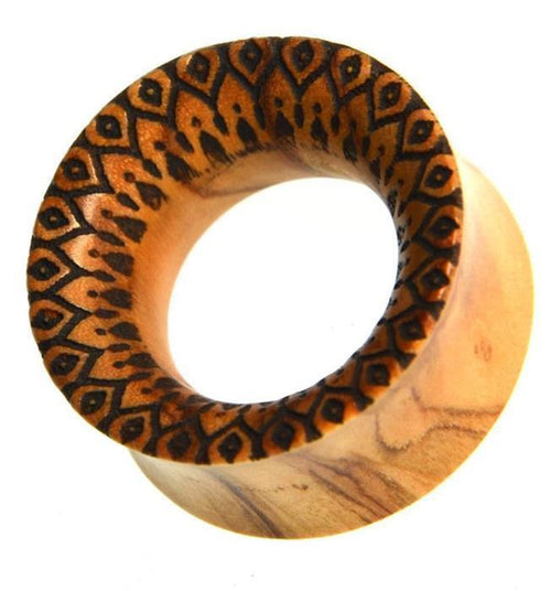 The Holz Plug Olivenholz Sonnenblume is a handmade, double flared ear gauge plug crafted from light brown olive wood with visible grain and an intricate black sunflower design around the front rim for a natural, artistic look.