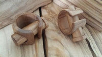 Load image into Gallery viewer, Two wooden puzzles with interlocking pieces rest on a light wood surface, their smooth brown grain and polished finish echoing the craftsmanship of the Plug Olivenholz Pin-Creole braun gemasert Holz-Pin Creole.
