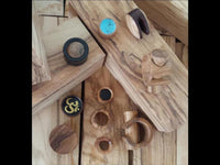 Load image into Gallery viewer, The Plug Olivenholz Pin-Creole braun gemasert Holz-Pin Creole features unique wood grain patterns in brown, displayed on light textured wood planks. This Piercing Schmuck comes in various sizes and shapes with distinctive designs.
