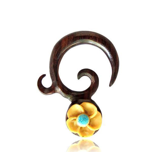 The handgeschnitzte Piercing Sonoholz Spirale Kokosschale Blume Expander gemasert besticht durch ein dunkles Spiraldesign und eine kleine gelbe Blume mit blauem Zentrum – ideal für dein nächstes Piercing.