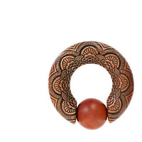 Load image into Gallery viewer, The Captive Bead Klemmkugel Ring Sawoholz Piercing Mandala is a round metal ornament with intricate floral engravings and an open circle design, featuring a Sawoholz expander bead between the open ends at the bottom.
