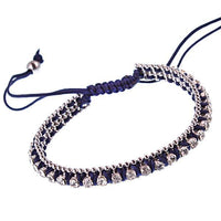 Load image into Gallery viewer, The Brass Armband Glaskristalle Satinfaden Damen 26 cm features shiny silver beads, glass crystals, and rhinestones on a dark navy satin cord with an adjustable sliding knot closure.
