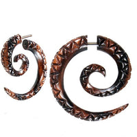 Load image into Gallery viewer, A pair of Fake Spirale Lobe Piercing earrings, crafted from dark brown wood with carved triangles and a spiral design. Each Dehnschnecke features a stainless steel post—ideal Holz Ohrstecker Dehner for fans of fake piercings.

