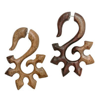 Load image into Gallery viewer, A pair of hand-carved Fake Piercing Sonoholz Edelstahl earrings in large size, featuring a unique abstract swirl design with hook-like tops and multiple curved extensions in light and dark brown wood.
