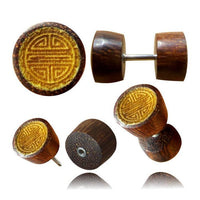 Load image into Gallery viewer, The Fake Holz Plug Symbol Piercing features stainless steel posts and tamarind jackfruit wood with engraved Shou, Om, and Vegvisir symbols, creating a stylish cylindrical design ideal for lobe piercing enthusiasts.
