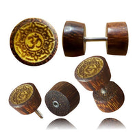 Load image into Gallery viewer, Five views of the Fake Holz Plug Symbol Piercing, made from tamarind and jackfruit wood with carved Om inlay on the round front. Features stainless steel post; ideal as a stylish lobe piercing or fake plug accessory.
