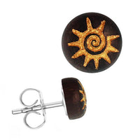 Load image into Gallery viewer, The Holzohrstecker Edelstahl Sonoholz rund 8mm features a dark brown, round design with a gold sun spiral motif on the front and a silver stainless steel backing visible from both front and side views.
