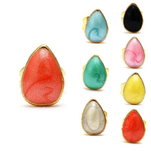 Eight colorful Brass Ohrstecker Stern earrings in coral, blue, black, pink, green, yellow, white, and light yellow are displayed in a grid, with the coral earring shown larger. These 12 mm Edelstahl earrings are unisex and nickelfrei for sensitive skin.