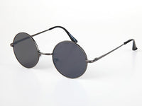 Load image into Gallery viewer, The Sonnenbrille Unisex Rund Hippie Brille John Lennon 400UV features round black sunglasses with thin metal frames and dark lenses, inspired by the iconic John Lennon style, displayed on a white surface.
