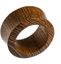 Load image into Gallery viewer, A close-up of the Teakholz Flesh Tunnel braun double flared Plug, featuring a smooth, circular shape and natural wood grain, set against a white background.
