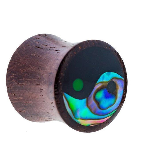 The Sonoholz Plug Yin Yang Inlay features vibrant paua abalone resin in a black tunnel expander, offering a tribal-inspired wooden ear plug with an eye-catching yin-yang design.