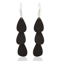 Load image into Gallery viewer, These Holzohrringe Tropfen lang (68 mm) feature three stacked, matte black, teardrop-shaped pieces on each earring, hanging from stainless steel hooks—stylish, nickel-free, and perfect for everyday wear.

