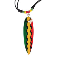 Load image into Gallery viewer, The Surferkette Haifzahn features a round surfboard-shaped pendant with green, yellow, and red stripes, wavy lines, and a white flower on a black cord with colorful beads—perfect for surf style vibes. Adjustable and accented with wood and shell.
