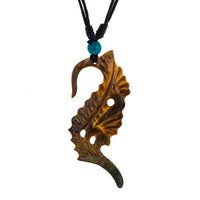 Load image into Gallery viewer, A hand-carved necklace features a stylized pendant from muschel perlmutt, hanging on an adjustable black cotton cord with a turquoise bead—Halskette Perlmutt verstellbar Baumwolle Muschel Kette Tomoe.
